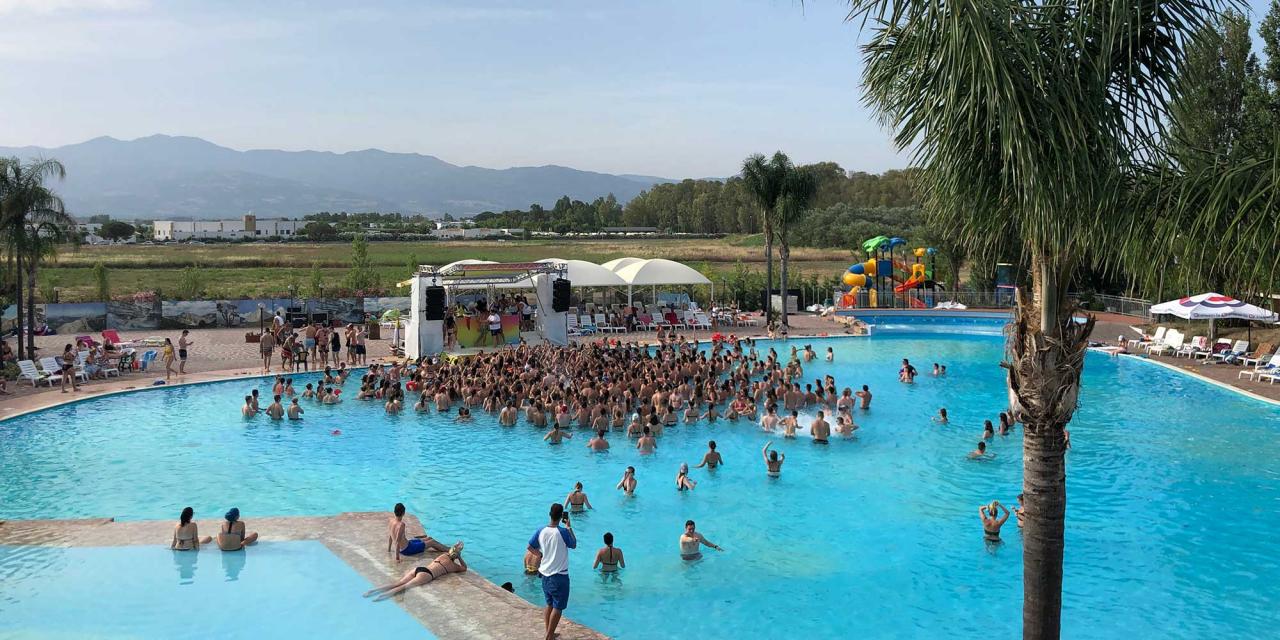 Students celebrate in a pool their spring break event