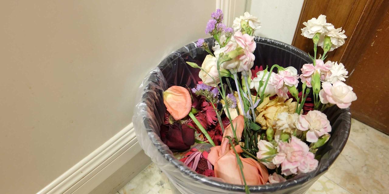 Weggeworfener Blumenstrauß im Mistkübel