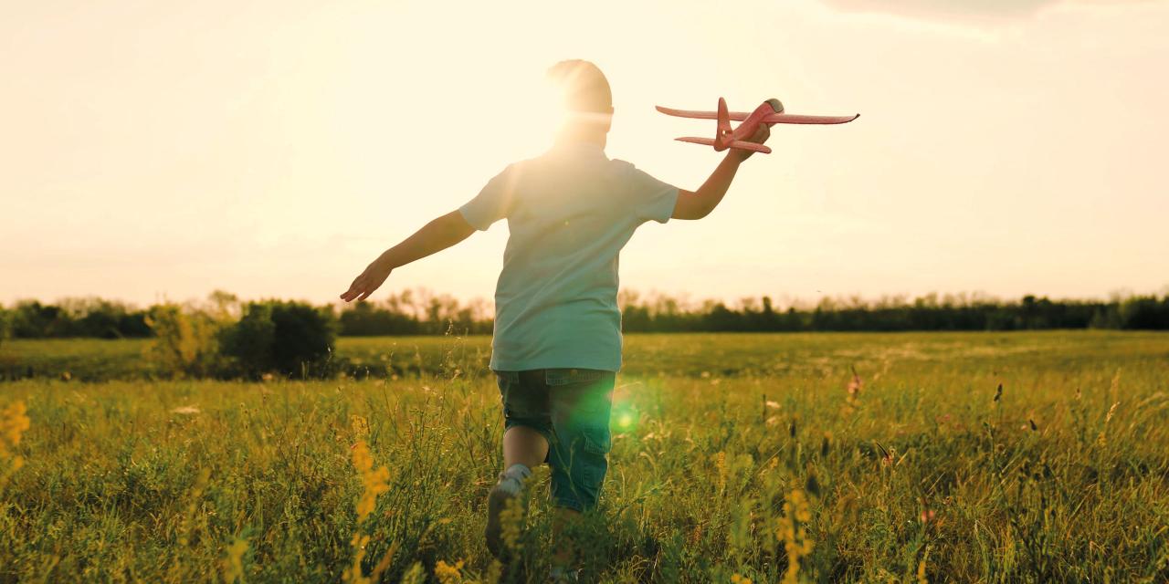 Kind mit Modellflugzeug in der Hand