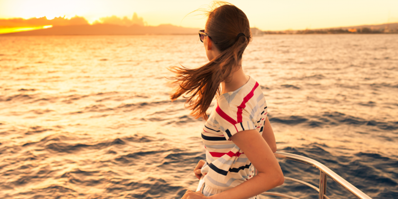 young woman at tip of a ship