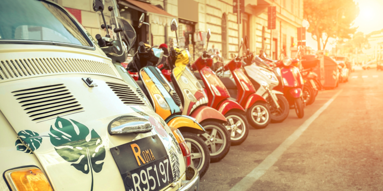 Parked cars and scooters on Italian side street