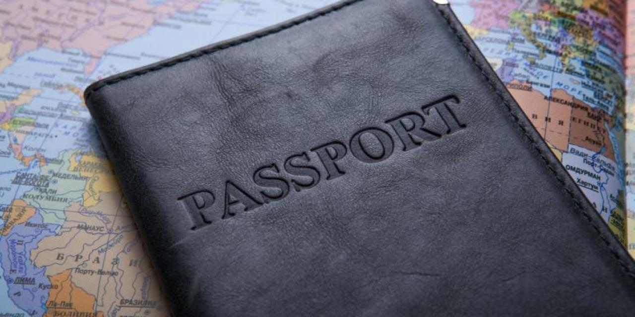 Passport in leather case on map