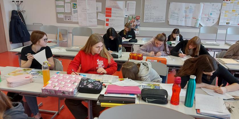 Schülerinnen am Schreibtisch mit KONSUMENT