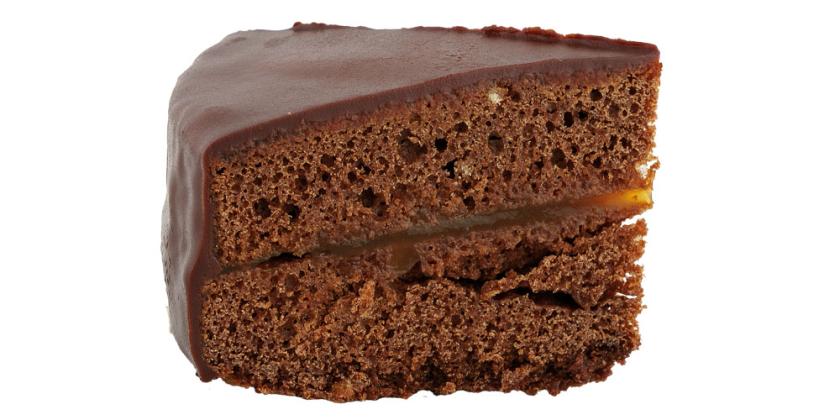 Sachertortenstück von der Seite vor weißem Hintergrund