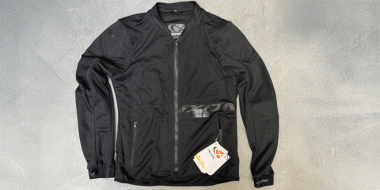 Liegende schwarze Motorradjacke mit weißen beschrifteten Etiketten