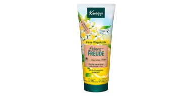 Eine Tube Kneipp Lebensfreude Aroma-Pflegedusche in gelbem Design mit weißen Blumen im Design.