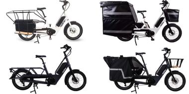 vier Lasten-E-Bikes, oben zwei weiße, darunter zwei schwarze