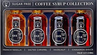 Auf dem Bild ist eine zuckerfreie Coffee Syrup Collection zu sehen. Vier kleine Glasflaschen stehen nebeneinander in einer dunklen Verpackung. Die Sorten sind French Vanilla, Salted Caramel, Hazelnut und Cinnamon Dolce. Jede Flasche hat ein schwarzes Etikett mit Nummerierung und goldbrauner Flüssigkeit.