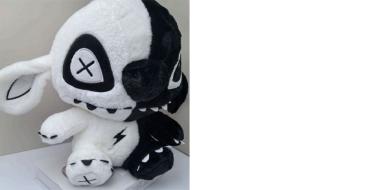 Plüschmonster, rechte Seite in Weiß, links schwarz