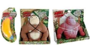 Auf dem Bild sind drei Spielzeuge der Reihe “Jungle Expedition” zu sehen. Links befindet sich eine gelbe Kunststoff-Banane in einer transparenten Verpackung mit Dschungelmotiv. Daneben stehen zwei plüschige Stretch-Gorillas in offenen Kartons, einer braun-beige, der andere rosa. Beide sitzen aufrecht in dekorierten Verpackungen mit grünen Blättern und tragen elastische Bänder um den Körper.