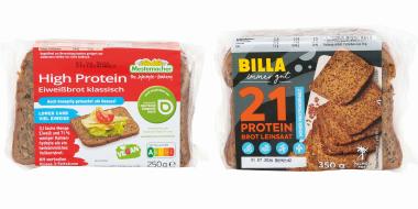 Zwei abgepackte Proteinbrote in transparenter Kunststofffolie vor weißem Hintergrund. Links liegt ein rechteckiges Paket mit rotem Etikett und der Aufschrift „High Protein EiweißBrot klassisch“. Das Etikett zeigt eine Brotscheibe mit Belag sowie verschiedene Hinweise wie „vegan“ oder „lower carb“. Rechts befindet sich ein größeres Paket mit dunklem Etikett und gelben Akzenten, beschriftet mit „21 Protein Brot Leinsaat“. Darauf sind mehrere Brotscheiben abgebildet.