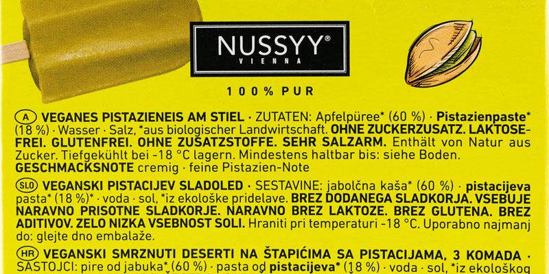Die Zutatenliste des Nussyy Bio Eis am Stiel der Sorte Pistazie in schwarz auf grün. 