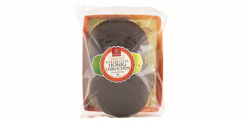 2 schokoladeüberzogene, runde Lebkuchen in Kartontasse mit transparenter Folie abgedeckt