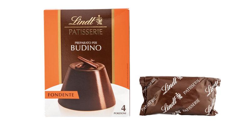 Neben dem Karton sieht man den zusammengerollten Beutel mit dem Produkt. Er reicht nicht einmal bis zur Hälfte. 